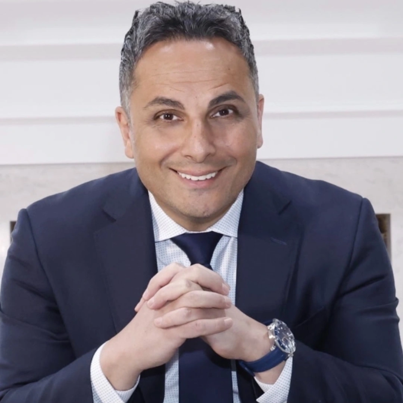 Will Soliman seated in a navy suit
